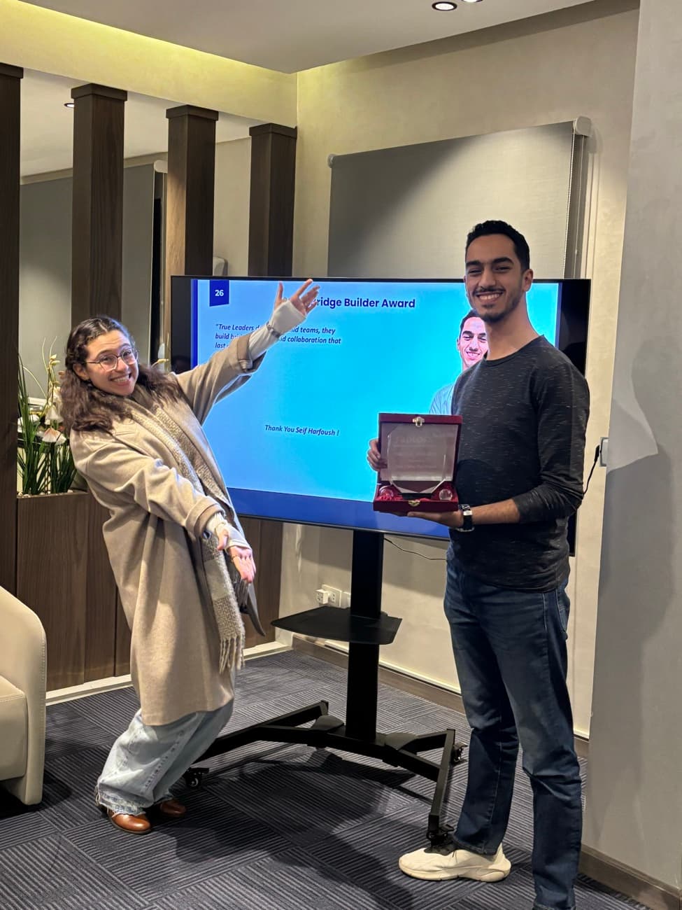 A colleague holding the Bridge Builder award.