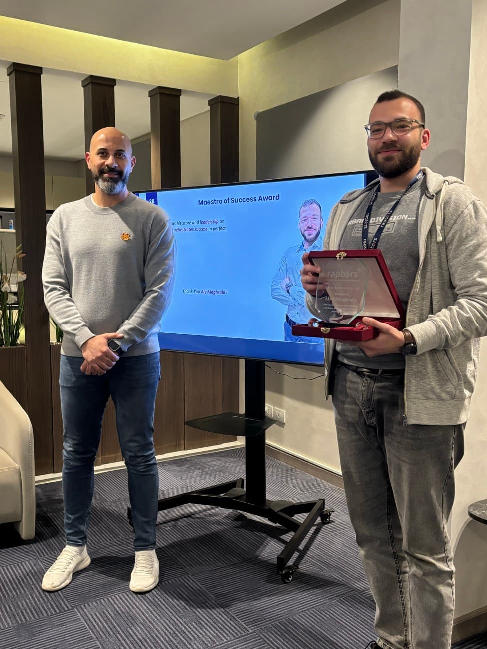 A team member holding the Maestro of Success plaque.