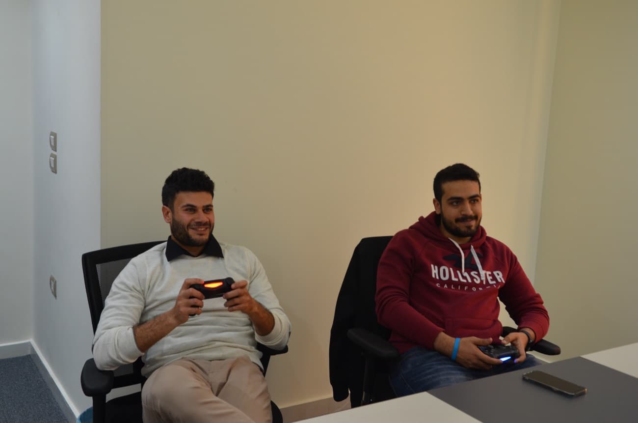 Two colleagues on a video-game break between builds.