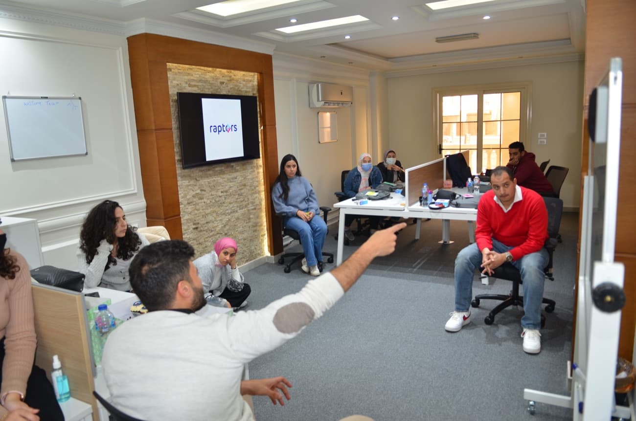 A workshop with the team gathered round.