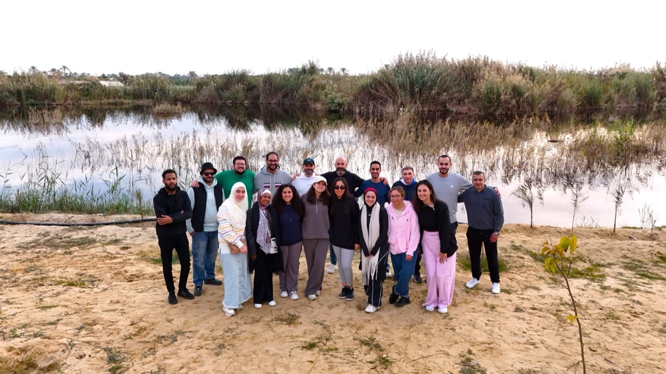 The team by the lake on the farm outing.